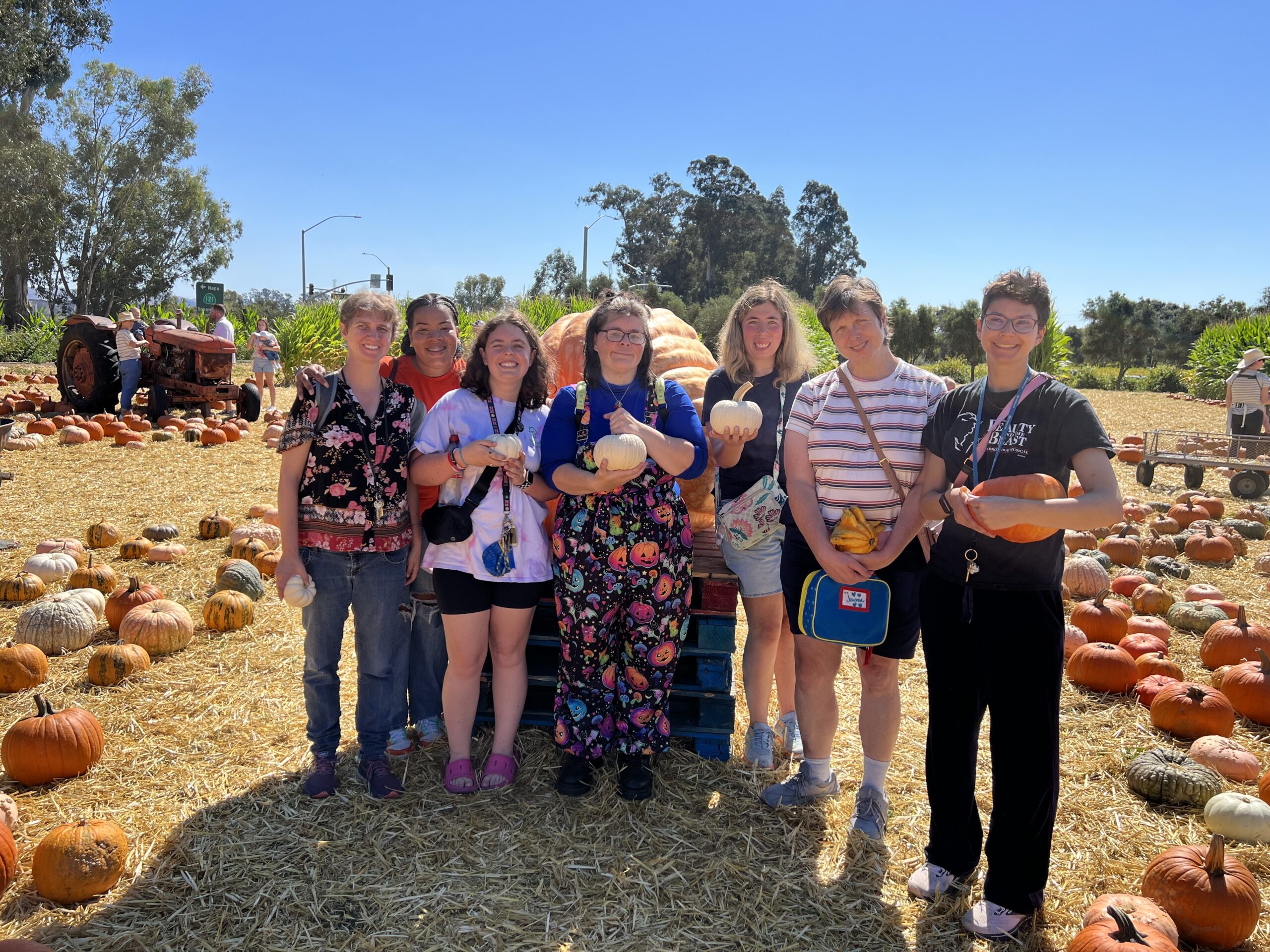 Group of people at a pumpkin patch.