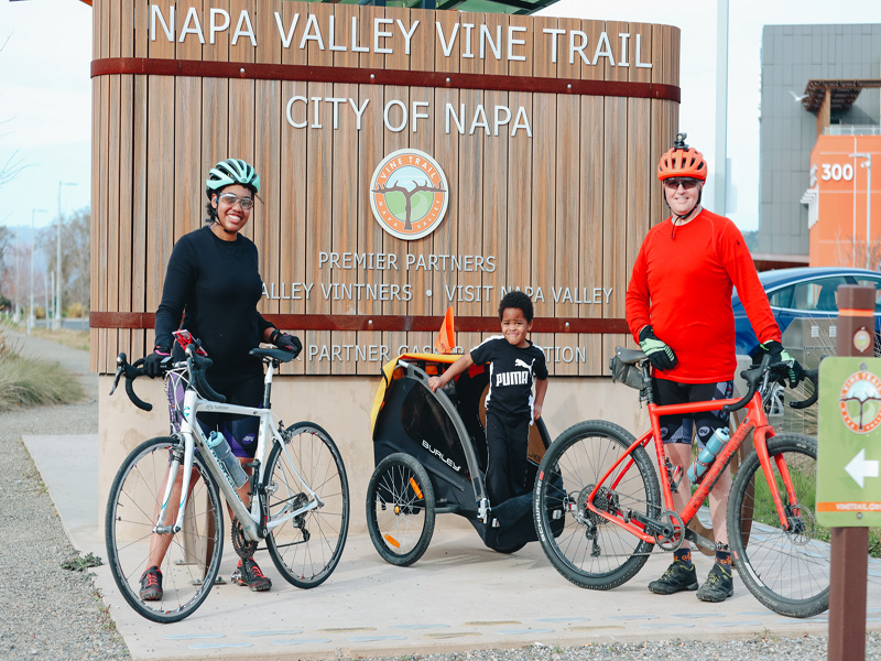 Cyclists at Napa Valley Vine Trail sign.